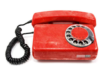 old dirty red telephone on white backgroundの写真素材