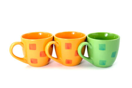 three colorful coffee cups on a white backgroundの写真素材