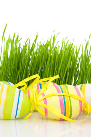 multicolored easter eggs and green spring grassの写真素材
