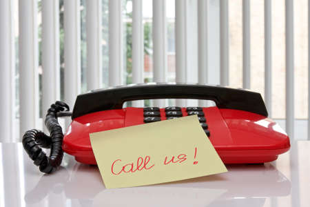 red office telephone with paper reminder の写真素材