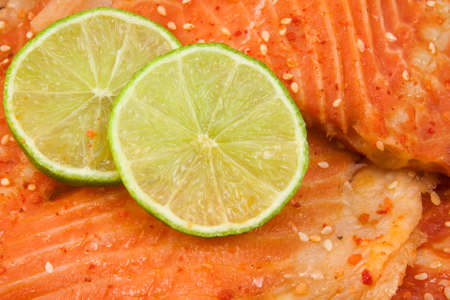 close up of salmon with green lemon.の写真素材