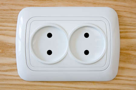 close up of white electric outlet on wooden  wall.の写真素材
