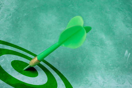 success conceptual. green dart hitting the target center.の写真素材