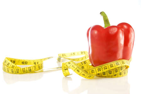 red pepper with a yellow measuring tape.の写真素材