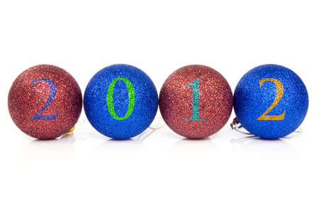   Christmas balls with 2012 date written on them in a horizontal row.