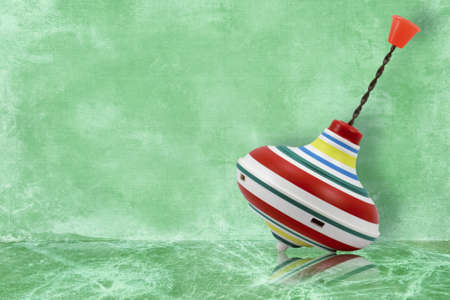 whirligig toy with reflection on blue backgroundの写真素材