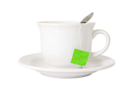 white tea cup with green leaf label. isolated on whiteの写真素材