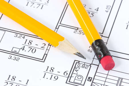 two yellow pencils on the building plan