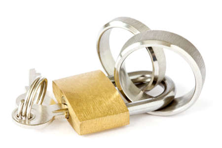 Together forever concept. golden padlock with wedding rings on white backgroundの写真素材