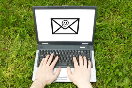 wireless techology usage concept  hands typing on a computer keyboard in a natureの写真素材