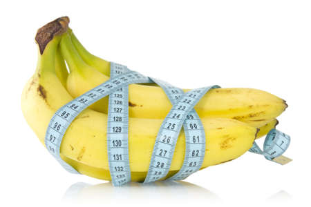 Bunch of bananas wrapped with measuring tape の写真素材