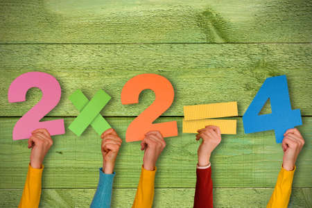 Education concept. Hands showing simple mathematical formula.の写真素材