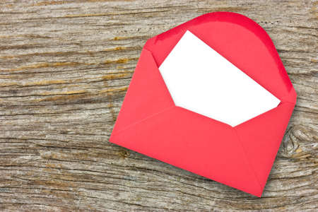 Red envelope with blank letter on wooden backgroundの写真素材
