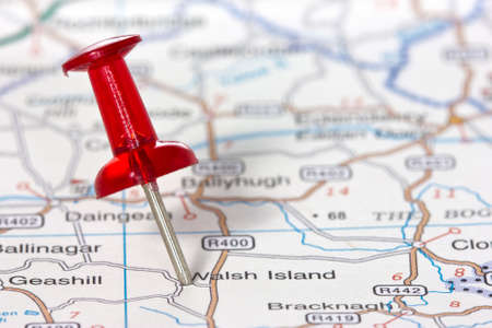Red pushpin showing the location of a destination point on a map の写真素材