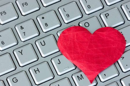 Red heart on the computer keyboard. Internet dating conceptの写真素材