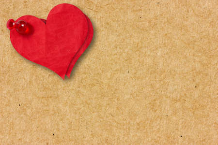 Two red paper hearts pinned to the  cardboard の写真素材