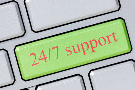 Keyboard with green 24/7 support button, business conceptの写真素材