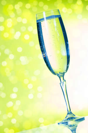 Elegant champagne glasses on the green background の写真素材