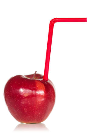 Red apple with  straw over a white backgroundの写真素材
