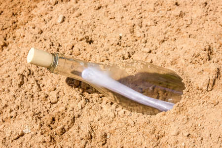 Bottle with a message  in the sand の写真素材