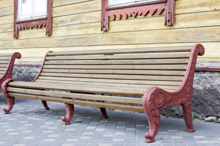 Vintage wooden bench in a yard of old houseの写真素材