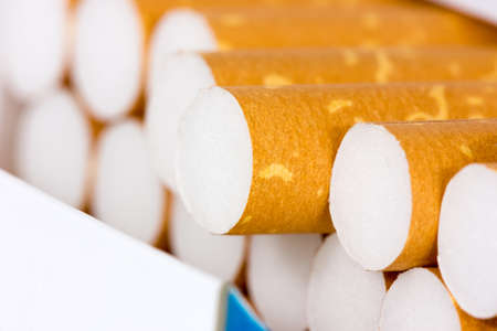 Close-up of cigarette sticking out from the pack 