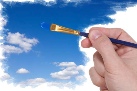 Artist brush painting blue sky with clouds の写真素材