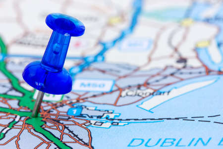 Closeup of blue pushpin on the map の写真素材