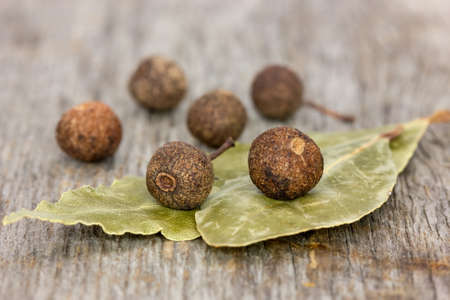 Laurel leaves and pepper on a wooden background の写真素材