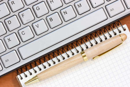 Spiral notebook and  computer keyboard. Close up view .の写真素材