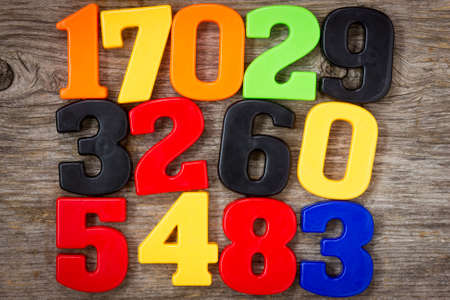 Colorful plastic numbers on the wooden backgroundの写真素材
