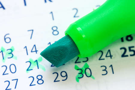 Close up of a calendar and green marker の写真素材