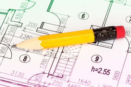 Engineering and architecture drawings with yellow pencil