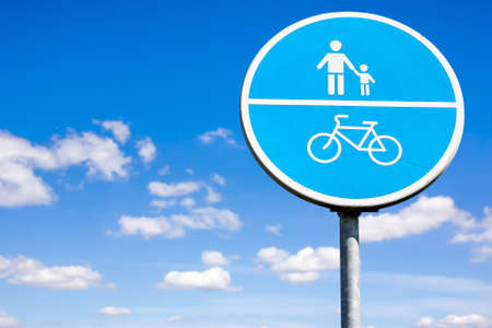 Bicycle and pedestrian shared route sign on the sky backgroundの写真素材