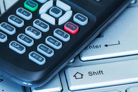 Mobility concept. Computer keyboard and mobile phone. 