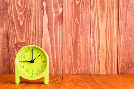 Alarm clock on the wood background. With copy-space for textの写真素材