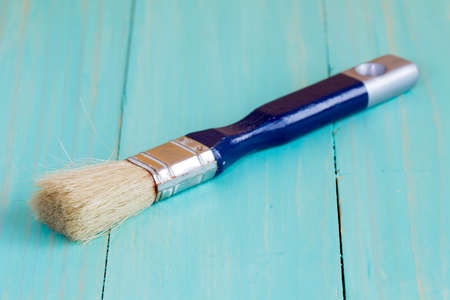 Paint brush on a wood surface, close upの写真素材