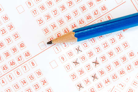 Pencil and lottery ticket with ticked numbersの写真素材