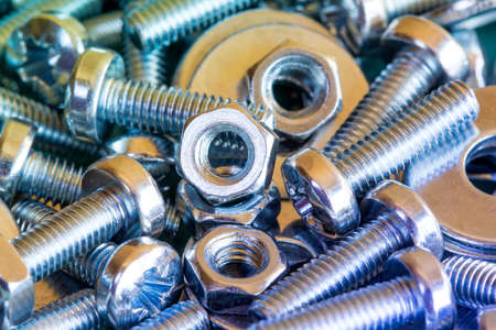 Chrome bolts and nuts close-up with colorful toneの写真素材