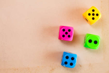Four color dice on the cardboard background with copy-spaceの写真素材