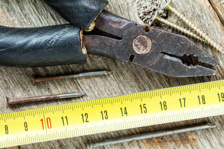Old tools of carpenter on the wooden background