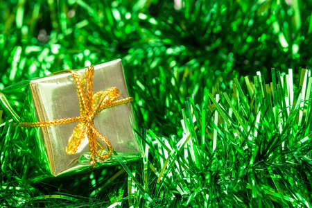Christmas decoration with green  tinsel and little gift boxの写真素材