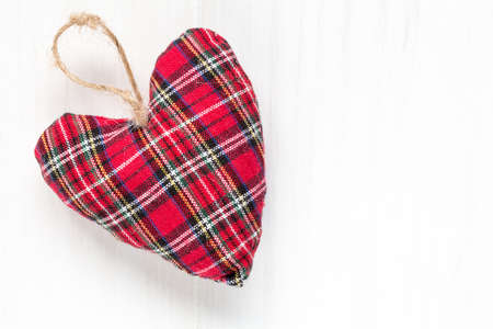 Decorative fabric heart  on white wood background with copy-spaceの写真素材
