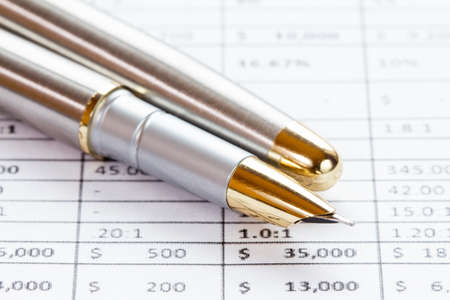 Accounting in process with  pen and financial chartsの写真素材