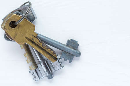Bunch of old keys on wooden bakground with copy-space
