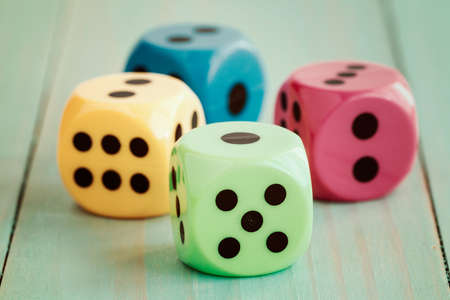 Dices on wooden floor in vintage color tone. Abstract background to risk management conceptの写真素材
