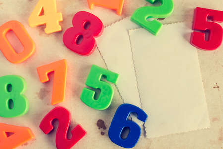 Colorful plastic numbers with empty cards for your text. Vintage image.の写真素材