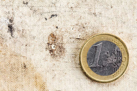 One Euro on old canvas background with copy - space
