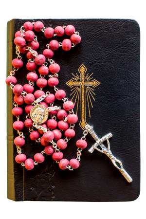 The bible with rosary isolated on white background