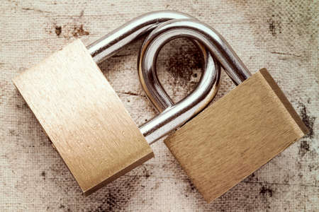 Two linked padlocks symbolizing good relationships or marriageの写真素材